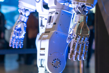 Closeup of metal robot hand. Concept of modern technology. Blue tone