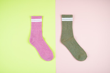 Multicolored socks on a pastel multi-colored pink and green background