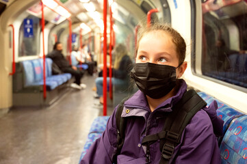 New normal. Young teenage girl with face covering mask on the subway. Mask against covid, pandemic. Teenager with face mask.