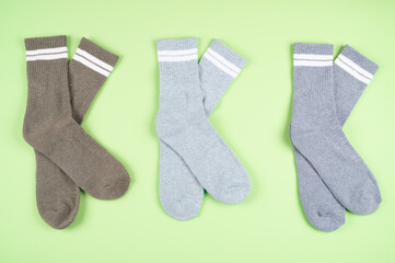 Set of warm socks on a pistachio-colored background
