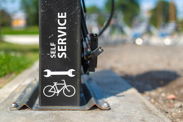 Detail of a public self bicycle service post with all the necessary tools for repair.