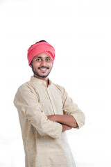 Young indian farmer standing on white background