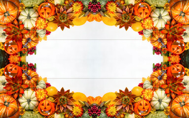 Harvesting.Autumn frame made of pumpkins, leaves, rowan berries and succulents on a white wooden...