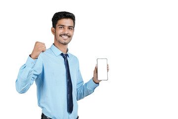 Young indian officer or student showing smartphone screen on white background.