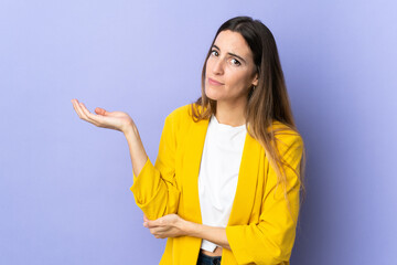 Young caucasian woman over isolated background having doubts