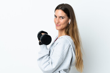 Fototapeta premium Young sport woman over isolated background making weightlifting