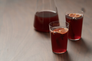 Mulled wine in tumbler glasses on walnut table with copy space