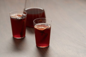 Mulled wine in tumbler glasses on walnut table with copy space