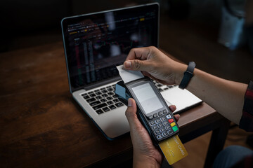 Card with contactless technology,Payment transaction with card,Online payment,Man hands holding a credit card and using smart phone for online shopping,Online shopping concept.