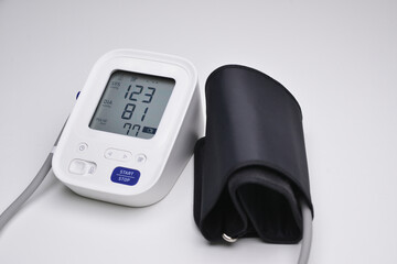 Close-up of digital blood pressure monitor with indicators of measurements on the screen. Digital...