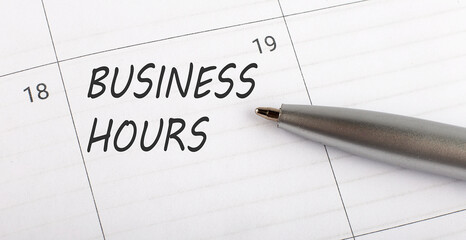Text BUSINESS HOURS written on calendar planner to remind you an important appointment with a pen on isolated white background.