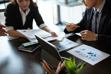 Young business people Are working together to analyze the current business in which direction to find profit in the business that started to invest.