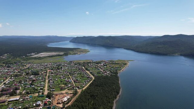 The Angara River is a major river in Siberia leaving Lake Baikal near the settlement of Listvyanka. Panoramic aerial view.