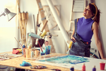 Fototapeta premium Happy female painter artist creating a new piece
