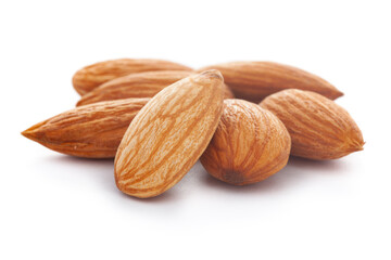 Micro close-up and details of Organic Indian brown almonds (Prunus dulcis) kernels isolated over white background.