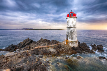 Gorgeous gloomy view of Capo Ferro Lighthouse.