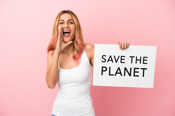 Young woman over isolated pink background holding a placard with text Save the Planet and shouting