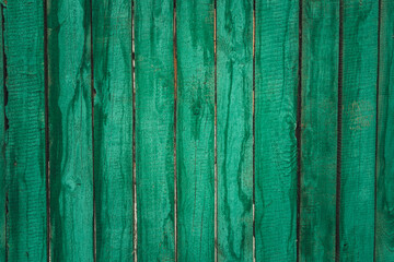 Vintage wood background with peeling paint. Wood Texture Background with natural pattern. Part of the wall is made of boards clapboard painted in green. 