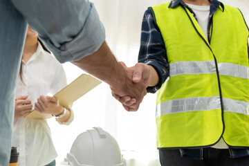 group of architect and engineer construction worker partner handshake in meeting room office at construction site building, industrial, partnership, construction contract and contractor concept