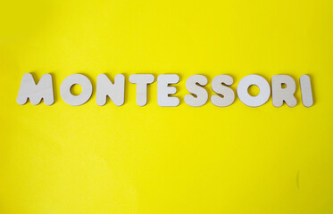 montessori logo on a yellow background
