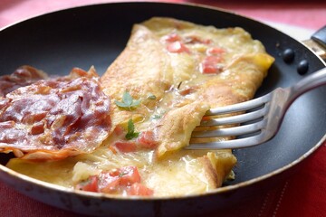 Omelet with tomato, cheese and marijuana leaf 