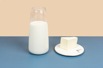 White milk and dairy products are placed on a yellow and gray background
