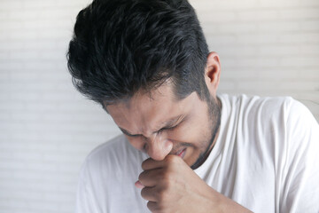 Fototapeta premium young sick man coughing and sneezes 