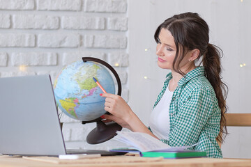 mixed-race business woman globe to convey she works for an international company. concept online...