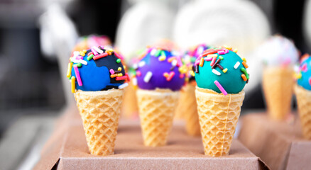 close up of yummy and colorful mini ice cream on waffle cone as a snack wit h pastel concept and...