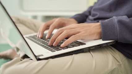Fototapeta na wymiar handsome asian man typing laptop at home