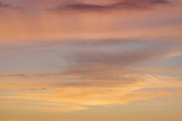    Beautiful evening blue sky at sunset with flaming bright light clouds. A warm summer evening at sunset. Bright sunset.         

