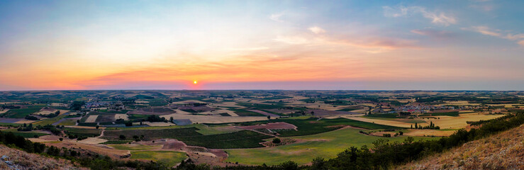 Stunning sunset. Panoramic view of the vineyards and other crops in the Ribera del Duero, where delicious wines are made. In Castilla y Leon, Spain. - obrazy, fototapety, plakaty