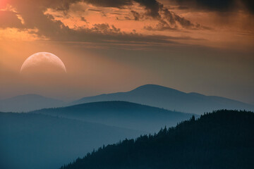 Obraz premium Beautiful landscape with big moon rising above the distant mountains (Courtesy of NASA).