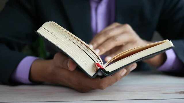 Close up of man's hand turning a pager of a diary 
