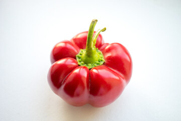 Thick ripe red peppers on a white table