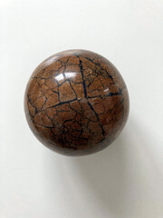 brown sphere over a blank background