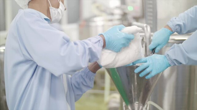 Scientist process ingredients into machinery. 