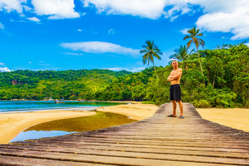 Mangrove and Pouso beach with traveler tourist Ilha Grande Brazil.