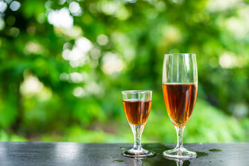 Red wine in small and large glasses placed on the bar.