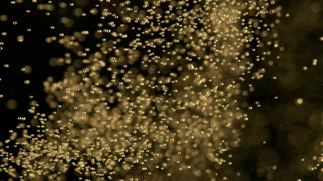 Super slow motion of champagne bubbles texture on black background. Filmed on high speed cinema camera, 1000 fps