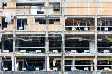 Opened, destroyed facade of a commercial modern building to be reconstructed.
