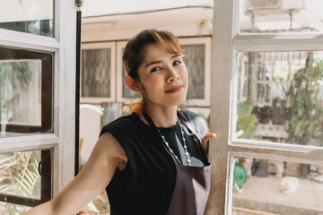 Portrait of happy Asian woman cafe and restaurant owner with face mask.