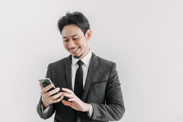 Happy smile face of Asian businessman use smartphone in concept of trading app.