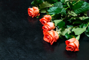 Bouquet of fresh red roses on a black background