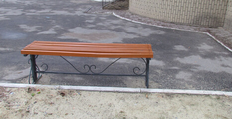 Wooden bench with ornamental metal supports