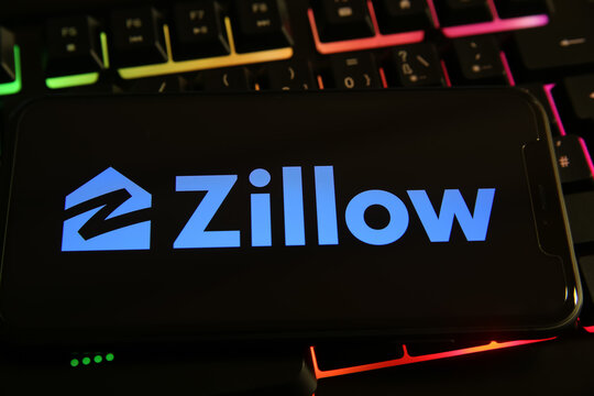 Viersen, Germany - June 9. 2021: Closeup of mobile phone with logo lettering of zillow on computer keyboard