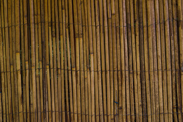 Bamboo mat tied with wire , brown background