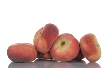 Several juicy organic peaches, close-up, isolated on white.