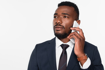 african american businessman in suit having phone conversation isolated on grey