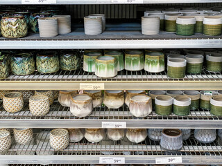 Green and beige flower pots for sale.